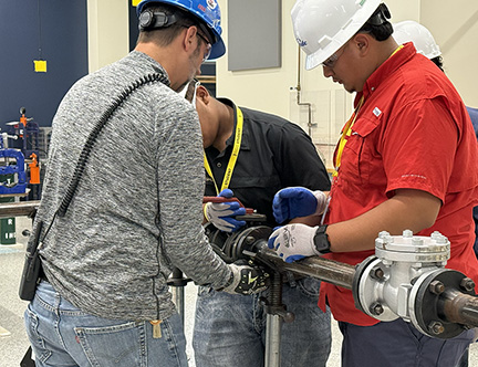 Summer camp working on pipe with three males