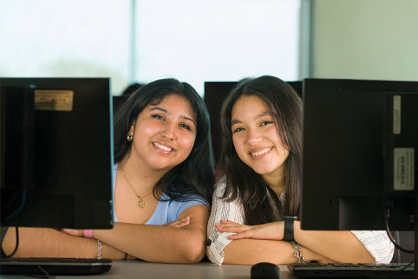 Two students sitting at desk.