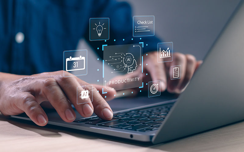 Person typing on laptop with artificial intelligence graphics superimposed in foreground